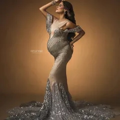 Pure glamour. This portrait showcases a stunning sequined mermaid gown against a warm, moody backdrop, creating a look of absolute luxury and confidence.