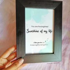 This simple black frame holds a watercolor-style print with the romantic quote, "You are the brightest Sunshine of my life," making it a sweet and minimal gift.