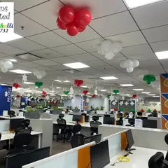 Another view of the Christmas office decorations, showing how the red, green, and white balloon clusters add festive cheer throughout the workspace.