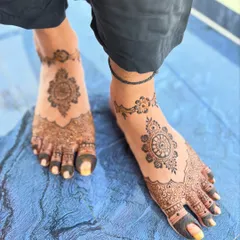 This design features a central mandala on the top of the foot with simple patterns extending to the toes. It's an elegant choice that pairs well with any hand design.
