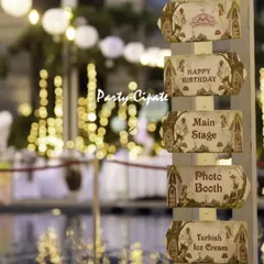 The little details make an event truly personal. For this enchanted forest themed birthday party, we created a custom wooden signpost to guide guests to the main stage and photo booth. Set against the poolside with twinkling lights, it added a touch of whimsy and practicality to the celebration.