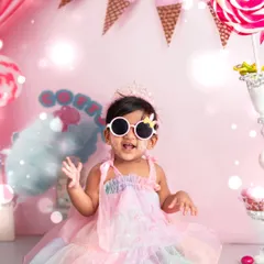 Striking a pose with her cool sunglasses, this little girl is the star of her first birthday party. Our themed cake smash sessions include fun accessories to match your child's personality.