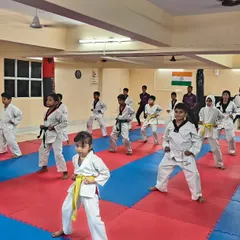A full class of students practicing their ready stance. This image captures the focus and unity we build in our Taekwondo programs.