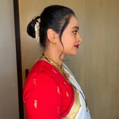 A classic and clean hair bun, perfect for a traditional Nauvari saree look. I added a gold accessory to match her jewelry.