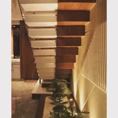 A close-up of a modern staircase design, featuring an under-stair planter and accent lighting that turns a functional element into a beautiful design feature.