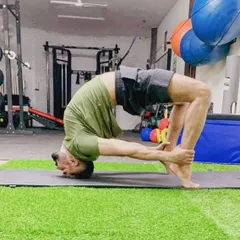 This is an advanced variation of Urdhva Dhanurasana, or Wheel Pose, where I hold my ankles to deepen the backbend. This posture requires significant spinal flexibility and shoulder opening, building strength throughout the entire body.
