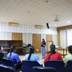 A wide view of a workshop session where our facilitator engages the entire group of young female athletes. The setup is designed for active participation, ensuring every athlete is part of the conversation about their future careers.