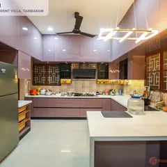 A wide view of a luxurious mauve kitchen in a 6BHK independent villa. The high-gloss finish and modern pendant light create a glamorous and inviting space, perfect for a large family.