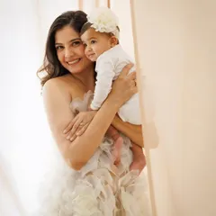 A tender moment between mother and child. The soft, neutral tones and the mother's gentle embrace create a feeling of warmth, love, and security.