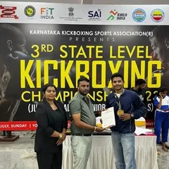 Here I am receiving an award on behalf of the academy at the state kickboxing championship. This is a win for our entire team.