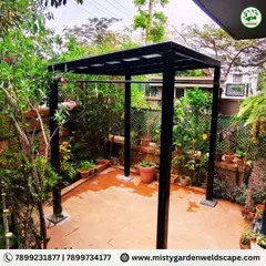The finished structure stands ready to provide a comfortable outdoor living area. The strong pillars are securely anchored to the ground for maximum stability.