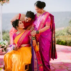 A touching moment between the bride and her family. The women in her life gather around to share their love and blessings, a beautiful candid moment from the wedding day.
