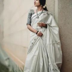 The simplicity of this white saree is captured with soft, even lighting. This minimalist approach puts the focus entirely on the garment's elegant design and texture.
