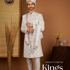 Grace fit for the kings. This ivory sherwani, detailed with fine embroidery and paired with a matching safa, is designed for a truly majestic wedding day entrance.