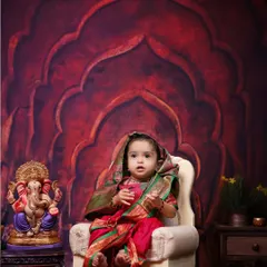 A beautiful portrait for Ganesh Chaturthi. This little girl is dressed in a traditional saree, sitting beside a Ganpati idol against a regal backdrop in my studio.
