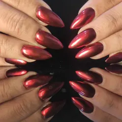 Feel the heat with these fierce stiletto nail extensions, coated in a vibrant, mirror-like red chrome finish that reflects light from every angle.