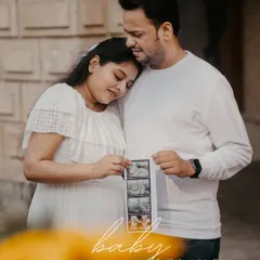 A heartwarming moment as a couple shares their sonogram pictures. These personal props make the maternity session uniquely yours, celebrating the life you're about to welcome.