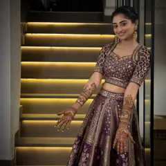 A full portrait of a radiant bride, showcasing how our intricate arm-length mehandi completes the perfect bridal look for her special day.