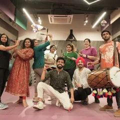Our members and trainers pose with dandiya sticks and a dhol during our Navratri celebration, blending culture, fun, and fitness.