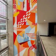 A closer look at the vibrant, geometric sections of the Embassy Group mural, showcasing the clean lines and colorful composition that bring the massive wall to life.