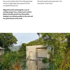 A linear pool clad in black and white granite slips beneath a row of existing mango trees at Villa Uma. The design carefully integrates the new construction with the mature vegetation on the site, preserving the natural character of the land.