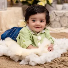 A pure and simple smile that lights up the room. This tummy time shot on a bed of soft clouds captures the innocent joy of a baby discovering the world around them.