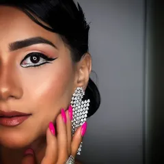 A perfect example of how nails complete a look. The bright pink manicure here isn't just an afterthought, it's a key part of this glamorous style, adding confidence and flair.