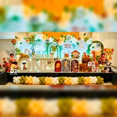 A wide view of Atharva's 'Wild One' celebration. The stage is filled with jungle animals, animal-print pedestals, and a large light-up 'ONE' sign, making it a perfect photo opportunity and a memorable centerpiece for the party.