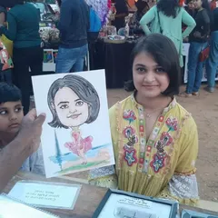 This young lady is showing off her ballerina-themed caricature from the "Ten Thousand Treasures" market event in Bangalore.
