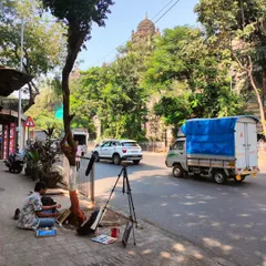 A typical workday, sketching on a sidewalk in Mumbai. My process is grounded in direct observation, finding art in the everyday flow of the city and its people.