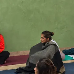 Finding warmth and stillness. A participant wrapped in a blanket during a deep rest session, embodying the comfort and peace we cultivate in our workshops.