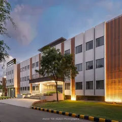 Another view of the Jindal Public School block at twilight. The lighting design highlights the architectural details of the facade, creating a welcoming and impressive presence on the campus.