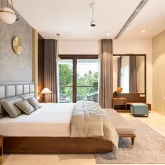 Natural light and views are key in this bedroom. The large windows connect the room to the lush greenery outside, while the mix of wood paneling and concrete-finish walls adds texture and warmth.