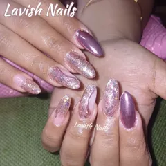 A stunning combination of metallic mauve and full-coverage pink holographic glitter on long, almond-shaped nails for a trendy and eye-catching effect.
