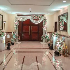 The entrance to the Holy Communion celebration, decorated with beautiful arches of pink and white flowers. The soft, welcoming design sets a serene and celebratory tone for the sacred event.