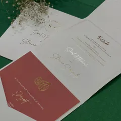 An inside look at our classy and minimal invitation. The suite includes a main card and a contrasting red insert for the Sangeet, all tied together with elegant typography.