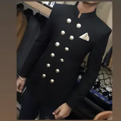 A close-up look at a custom-made black double-breasted Jodhpuri suit. The prominent silver buttons and precise shoulder fit demonstrate my commitment to detailed craftsmanship.