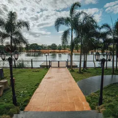 A beautiful pathway leading down to the lake, lined with palm trees and vintage-style lamps. It's one of the most picturesque spots in the resort.