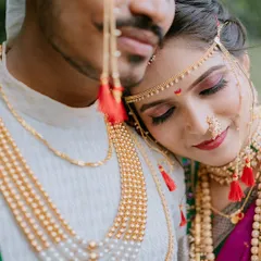 A detailed close-up shot focusing on the bride's serene expression and the magnificent traditional jewellery.