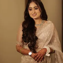 The complete engagement look. Her ivory saree is paired with a soft, luminous makeup style that enhances her features without overpowering them, creating a truly timeless appearance.