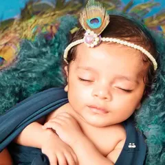 A close-up of a 28-day-old baby during his 'Little Krishna' photoshoot. We focus on capturing serene expressions and tiny details, ensuring your baby is comfortable and safe throughout the session.