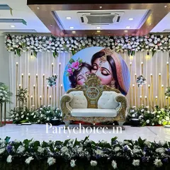 The same elegant baby shower stage, now with a royal sofa for the parents-to-be. The setup is perfect for photos and for the main ceremony.