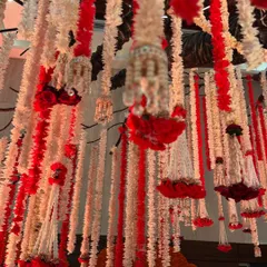 A close-up of the hanging floral strings, showing the intricate details of the flowers and the pearl-like accents.