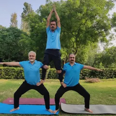 Our strong male yogis creating a pyramid pose during our International Yoga Day event.