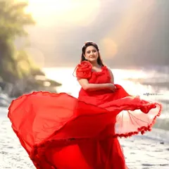 A stunning pre-wedding portrait session by the river in Rishikesh. The flowing red gown against the natural, sunlit backdrop creates a dramatic and romantic image, perfect for couples who want a fairytale-style photoshoot.