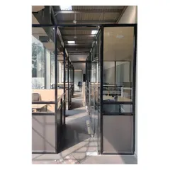 The main office corridor, lined with glass-walled cabins. This open-plan approach allows natural light to flood the workspace and promotes a sense of transparency and connection among the team.