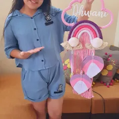Another great picture of Dhwani with her personalized macrame name hanging. It's wonderful to see my art bringing joy.