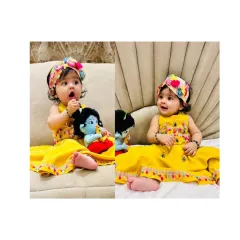 Our little Radha Rani celebrating Janmashtami. She looks absolutely adorable in our yellow ethnic dress with a colorful floral headband, holding her little Krishna doll.