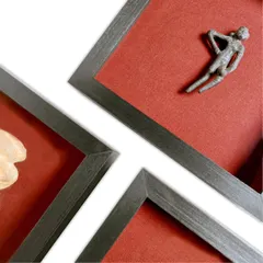 A close-up view of a framed historical artifact. The premium fabric mat board provides a soft, contrasting background, while the 99% UV museum glass ensures the piece is viewed without glare and is protected from light damage.