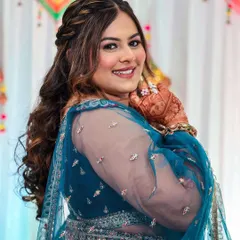 A happy bride is the most beautiful bride. This shot captures the joy of her sangeet, with her glowing makeup, soft curls, and colorful lehenga all coming together perfectly.